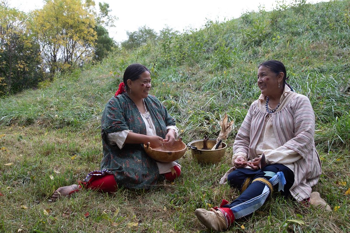 Indigenous women with traditional bowls